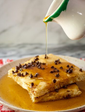 slices of sheet pan pancakes drizzled with syrup
