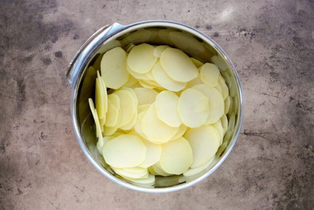 Dauphinoise potato gratin prep—sliced yellow potatoes.