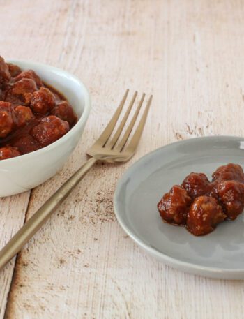 slow cooker barbecue meatballs appetizer in a bowl with a few on a plate