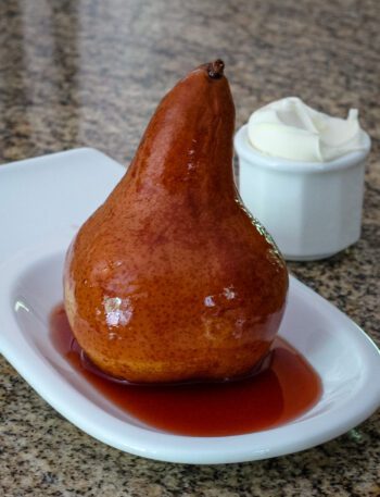 slow cooker wine poached pear on a serving dish