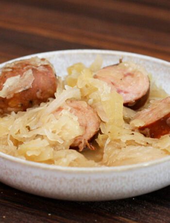 smoked sausages, sauerkraut, and apple meal in a bowl, cooked in the slow cooker