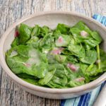 wilted spinach salad in a bowl