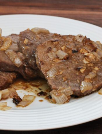 marinated steak and onions on a plate