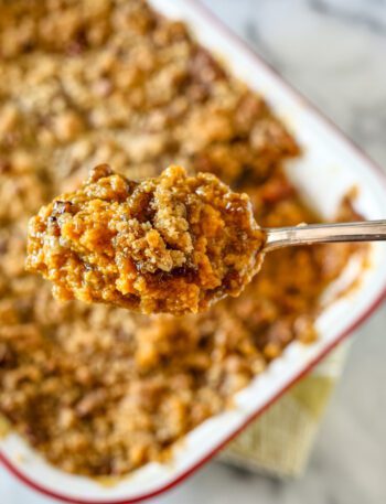 sweet potato casserole with coconut and pecans in a baking dish
