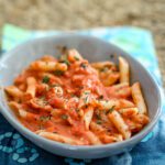penne pasta in a small dish with tomato cream sauce