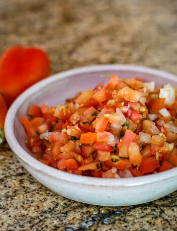 a small bowl of tomato salsa with chile peppers