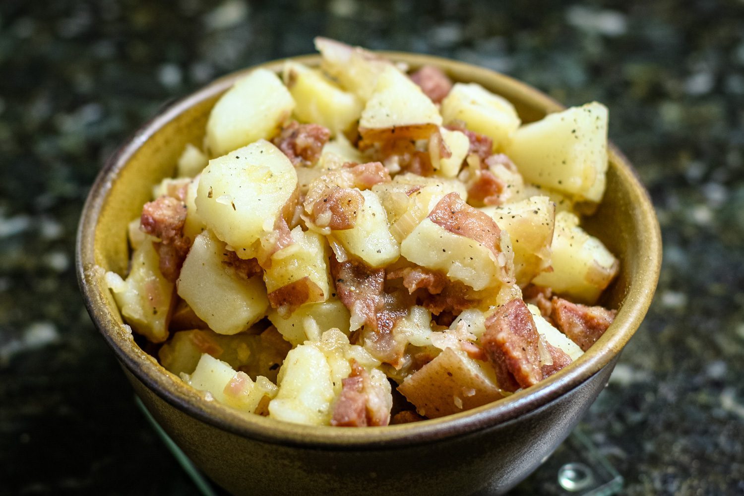 warm potato salad with sausage in a bowl